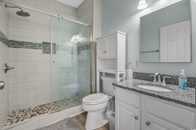 6015 Catalina Dr Unit 932, North Myrtle Beach, SC 29582 - bathroom with vanity, a shower stall, and wood finished floors
