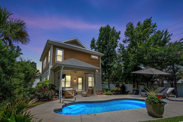 5 Ruth St, Murrells Inlet, SC 29576 - back of house at dusk featuring a patio
