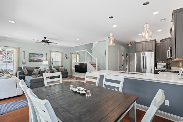 5 Ruth St, Murrells Inlet, SC 29576 - dining room featuring stairway, ceiling fan, recessed lighting, dark wood-type flooring, and crown molding