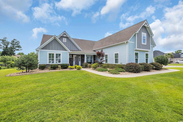 700 Shell Point Ct, Longs, SC 29568 - craftsman house featuring board and batten siding, a front yard, roof with shingles, and stone siding