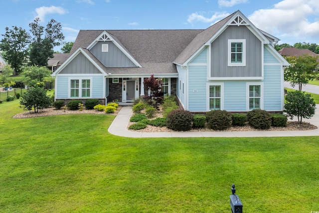 700 Shell Point Ct, Longs, SC 29568 - craftsman-style home with board and batten siding, a front yard, stone siding, and a shingled roof