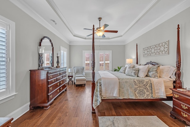 700 Shell Point Ct, Longs, SC 29568 - bedroom with a tray ceiling, dark wood finished floors, crown molding, and a ceiling fan
