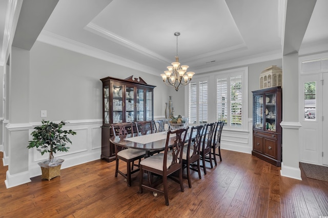 700 Shell Point Ct, Longs, SC 29568 - dining area with a tray ceiling, plenty of natural light, a chandelier, a wainscoted wall, and hardwood / wood-style floors