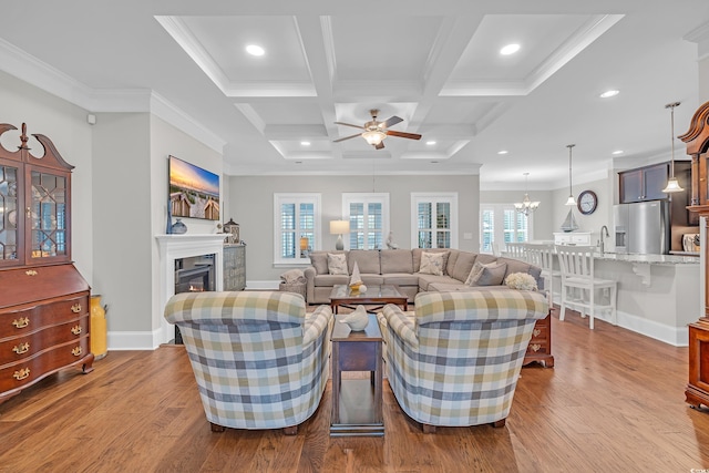 700 Shell Point Ct, Longs, SC 29568 - living area featuring a ceiling fan, wood finished floors, coffered ceiling, a glass covered fireplace, and ornamental molding