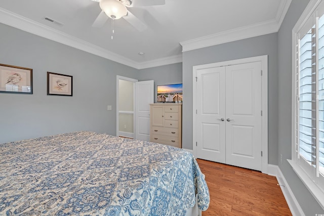 700 Shell Point Ct, Longs, SC 29568 - bedroom with crown molding, light wood-type flooring, ceiling fan, and a closet