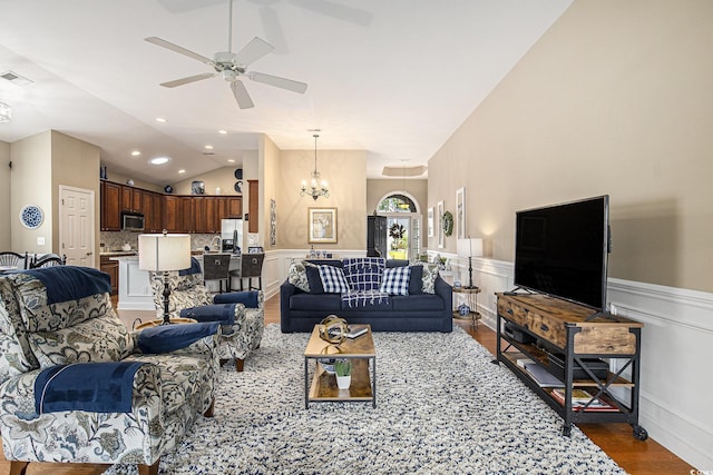 388 Sea Turtle Dr, Myrtle Beach, SC 29588 - living room featuring a ceiling fan, wood finished floors, vaulted ceiling, a chandelier, and wainscoting