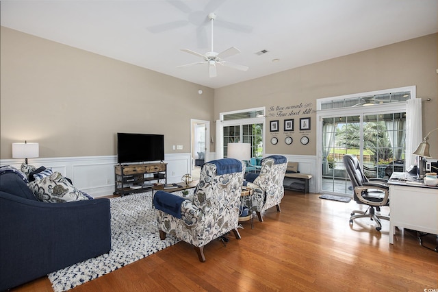 388 Sea Turtle Dr, Myrtle Beach, SC 29588 - living area with a desk, wood finished floors, ceiling fan, wainscoting, and a decorative wall