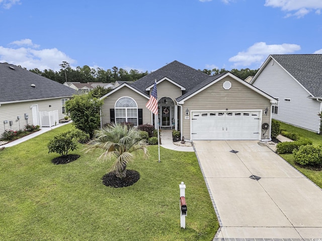 388 Sea Turtle Dr, Myrtle Beach, SC 29588 - view of front facade with an attached garage, driveway, a front lawn, and roof with shingles