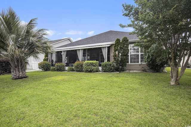 388 Sea Turtle Dr, Myrtle Beach, SC 29588 - view of front facade featuring a front yard, a sunroom, and roof with shingles