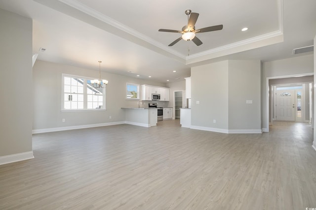 369 Log Cabin Rd, Loris, SC 29569 - unfurnished living room featuring a chandelier, light wood-type flooring, a raised ceiling, a ceiling fan, and recessed lighting