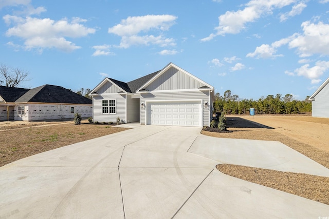 369 Log Cabin Rd, Loris, SC 29569 - view of front facade featuring board and batten siding, driveway, and an attached garage