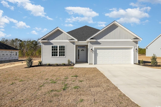 369 Log Cabin Rd, Loris, SC 29569 - view of front of property featuring a garage, board and batten siding, driveway, a front yard, and a shingled roof