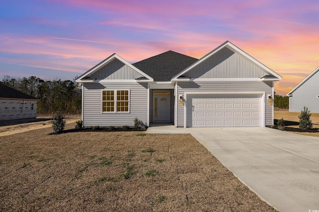 369 Log Cabin Rd, Loris, SC 29569 - view of front of house featuring an attached garage, concrete driveway, a front yard, board and batten siding, and roof with shingles