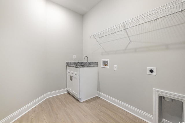 369 Log Cabin Rd, Loris, SC 29569 - laundry room featuring electric dryer hookup, light wood-style flooring, washer hookup, and cabinet space