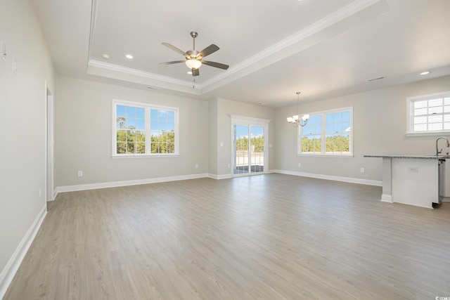 369 Log Cabin Rd, Loris, SC 29569 - unfurnished living room featuring a raised ceiling, a chandelier, healthy amount of natural light, ornamental molding, and light wood finished floors