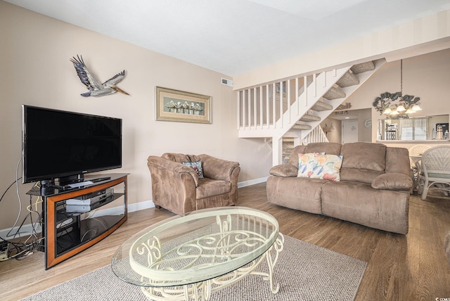 5505 N Ocean Blvd Unit 303, Myrtle Beach, SC 29577 - living room with wood finished floors, a chandelier, and stairs