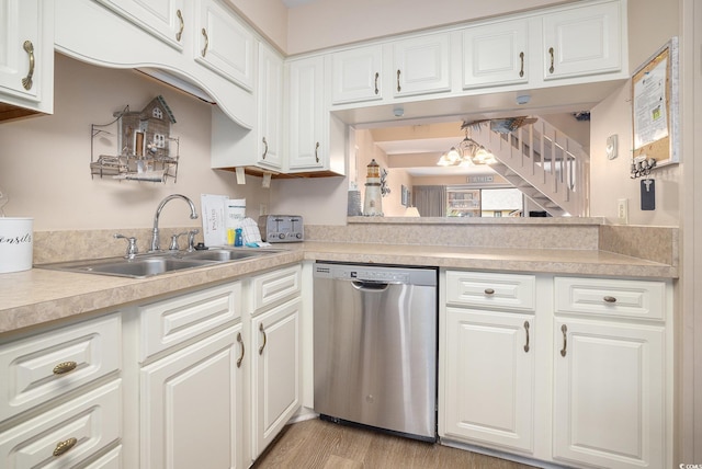 5505 N Ocean Blvd Unit 303, Myrtle Beach, SC 29577 - kitchen with stainless steel dishwasher, light countertops, a chandelier, and white cabinetry