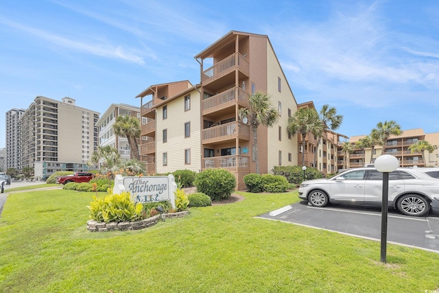 5505 N Ocean Blvd Unit 303, Myrtle Beach, SC 29577 - view of apartment building / complex featuring uncovered parking