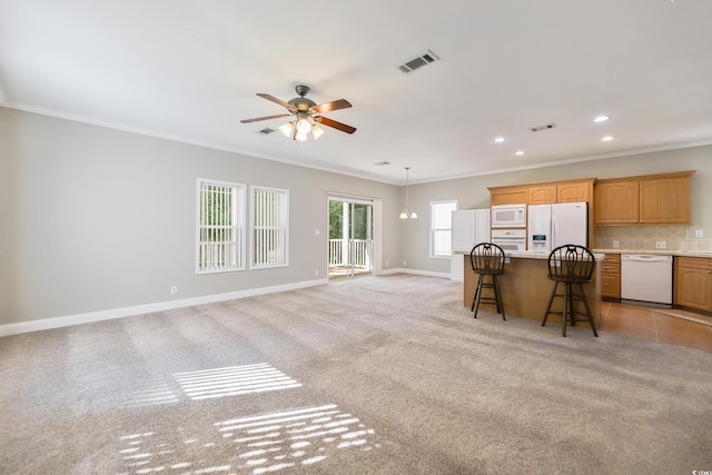 628 Lake Estates Ct, Conway, SC 29526 - kitchen with white appliances, a kitchen bar, light countertops, a ceiling fan, and crown molding