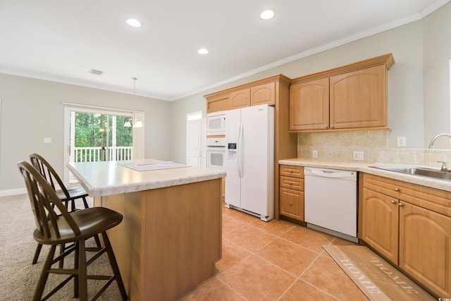 628 Lake Estates Ct, Conway, SC 29526 - kitchen featuring white appliances, a center island, a breakfast bar area, light countertops, and decorative backsplash