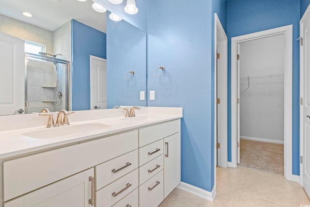 597 Heritage Downs Dr, Conway, SC 29526 - bathroom featuring double vanity, a stall shower, a walk in closet, and tile patterned floors