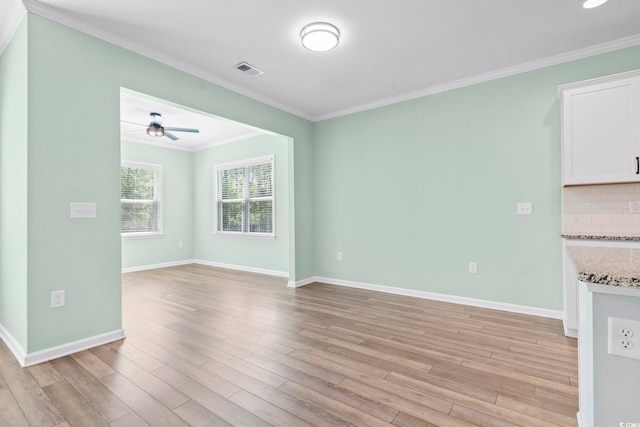 597 Heritage Downs Dr, Conway, SC 29526 - unfurnished living room featuring a ceiling fan, light wood-style floors, and crown molding