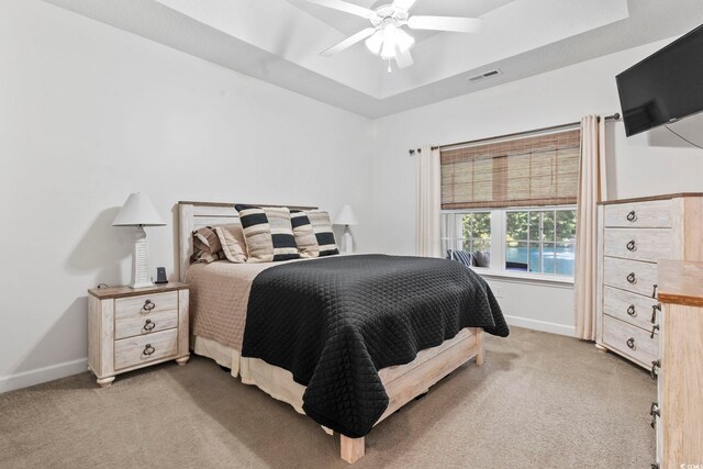 236 Palm Cove Cir, Myrtle Beach, SC 29588 - bedroom featuring light colored carpet, a tray ceiling, and ceiling fan