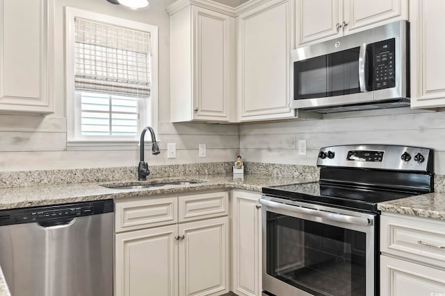 236 Palm Cove Cir, Myrtle Beach, SC 29588 - kitchen with appliances with stainless steel finishes, white cabinets, and light stone counters