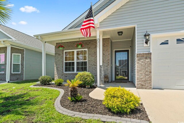 236 Palm Cove Cir, Myrtle Beach, SC 29588 - doorway to property with brick siding, covered porch, and concrete driveway