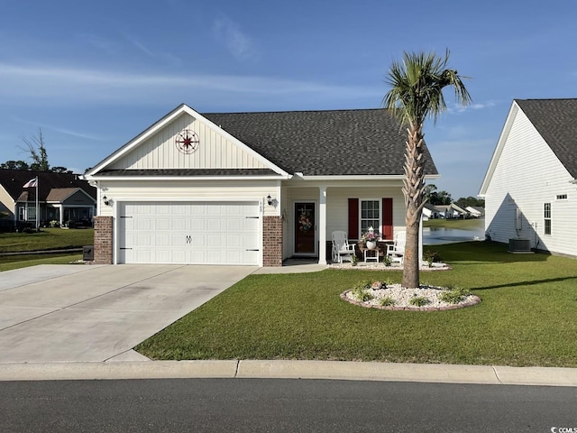 668 Rycola Cir, Surfside Beach, SC 29575 - view of front of home with brick siding, an attached garage, a porch, a front yard, and driveway