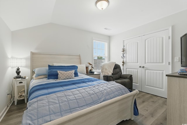 668 Rycola Cir, Surfside Beach, SC 29575 - bedroom featuring light wood finished floors, a closet, and lofted ceiling