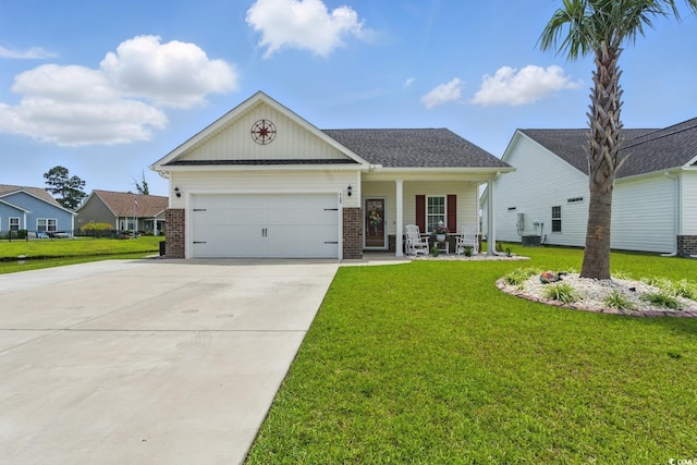 668 Rycola Cir, Surfside Beach, SC 29575 - view of front of house featuring a porch, concrete driveway, a front lawn, an attached garage, and brick siding