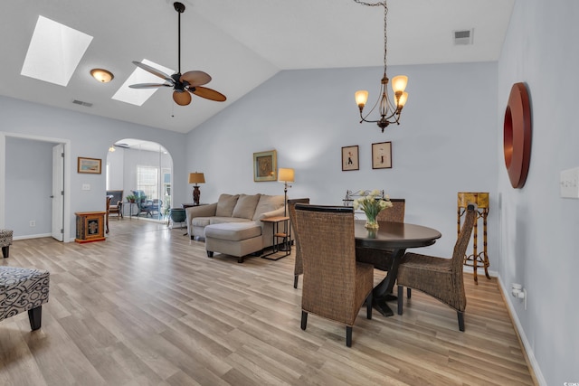 4520 Lighthouse Dr Unit 29B, Little River, SC 29566 - dining space featuring arched walkways, light wood-style flooring, ceiling fan, a chandelier, and high vaulted ceiling