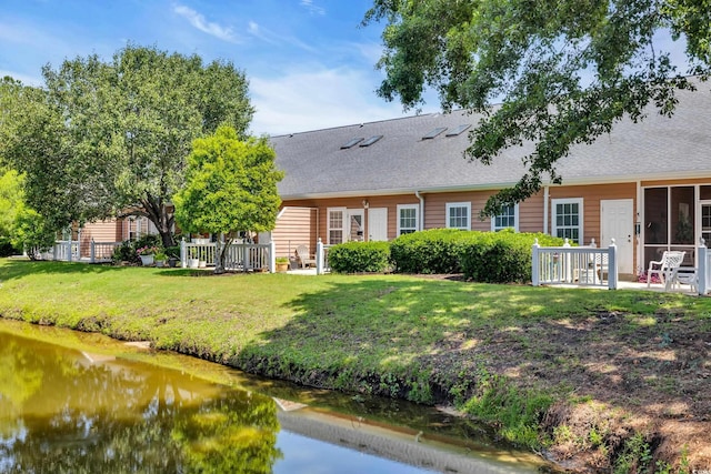 4520 Lighthouse Dr Unit 29B, Little River, SC 29566 - back of house featuring a shingled roof and a yard
