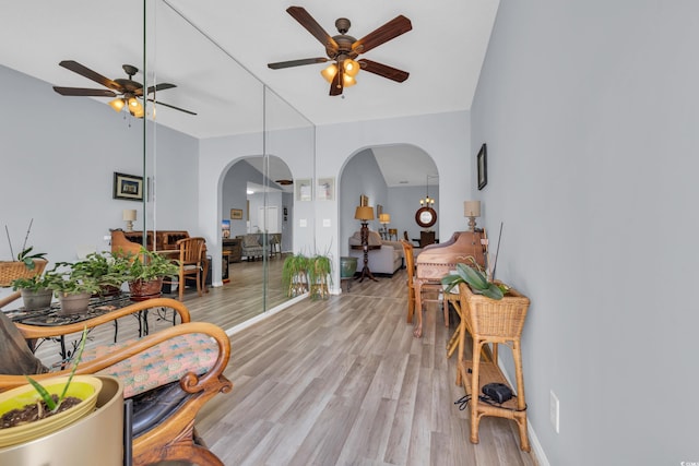 4520 Lighthouse Dr Unit 29B, Little River, SC 29566 - living room featuring arched walkways, ceiling fan, and light wood-style floors