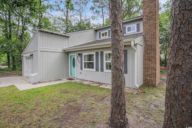 1930 Lake View Cir, Myrtle Beach, SC 29575 - mid-century modern home with a garage, driveway, and a shingled roof