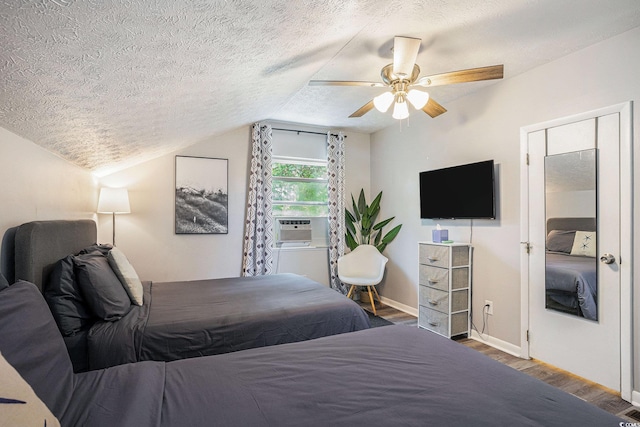 1930 Lake View Cir, Myrtle Beach, SC 29575 - bedroom with wood finished floors, a textured ceiling, vaulted ceiling, a ceiling fan, and cooling unit