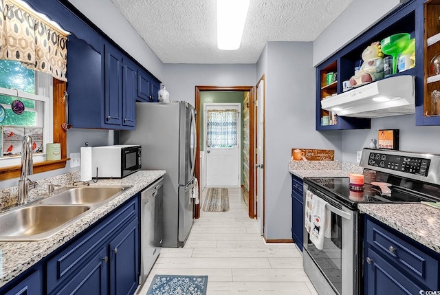 201 Surrey Ln, Myrtle Beach, SC 29579 - kitchen with appliances with stainless steel finishes, under cabinet range hood, blue cabinets, light wood-type flooring, and healthy amount of natural light