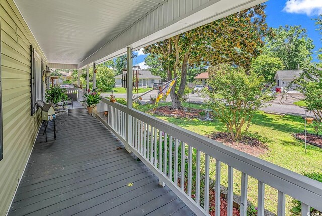201 Surrey Ln, Myrtle Beach, SC 29579 - wooden porch featuring a yard, a residential view, and grilling area
