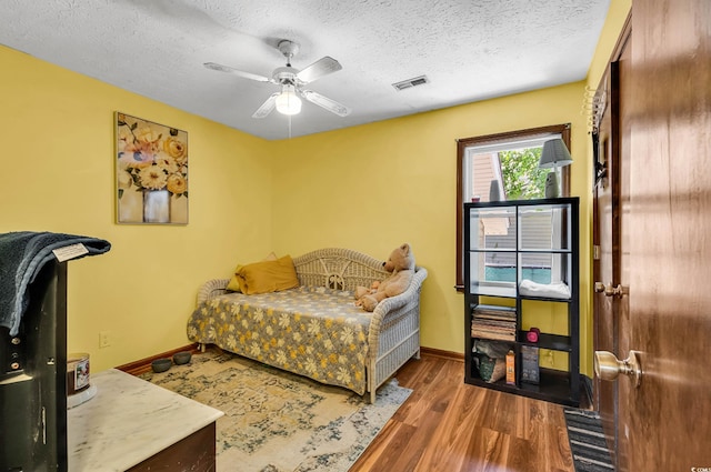 201 Surrey Ln, Myrtle Beach, SC 29579 - bedroom featuring a textured ceiling, wood finished floors, and a ceiling fan