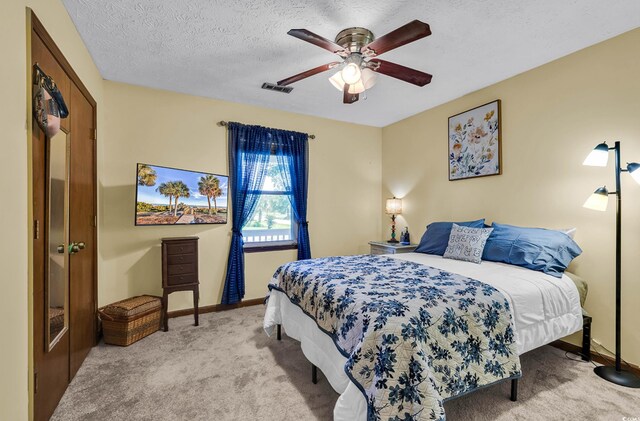 201 Surrey Ln, Myrtle Beach, SC 29579 - bedroom with light carpet, a ceiling fan, and a textured ceiling