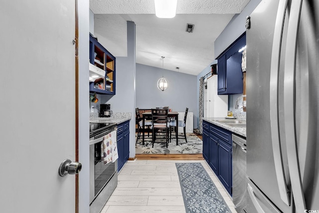 201 Surrey Ln, Myrtle Beach, SC 29579 - kitchen featuring blue cabinets, stainless steel appliances, light countertops, light wood-type flooring, and a textured ceiling