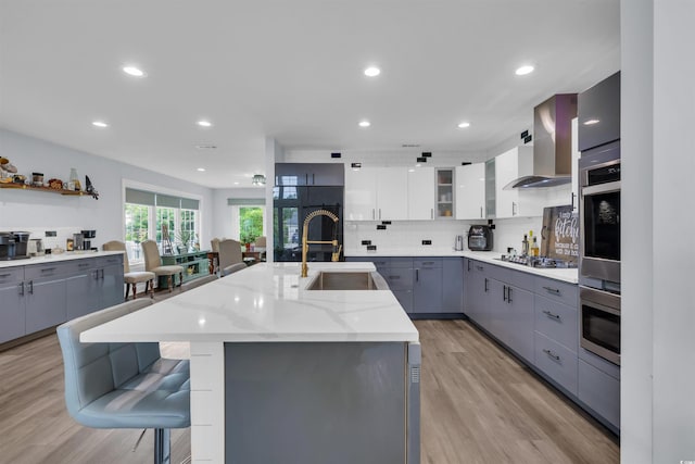 35 Easter Lilly Ct, Murrells Inlet, SC 29576 - kitchen featuring wall chimney range hood, appliances with stainless steel finishes, gray cabinets, backsplash, and recessed lighting