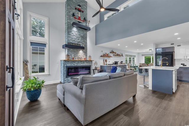 35 Easter Lilly Ct, Murrells Inlet, SC 29576 - living room featuring wood finished floors, healthy amount of natural light, a fireplace, a towering ceiling, and ceiling fan