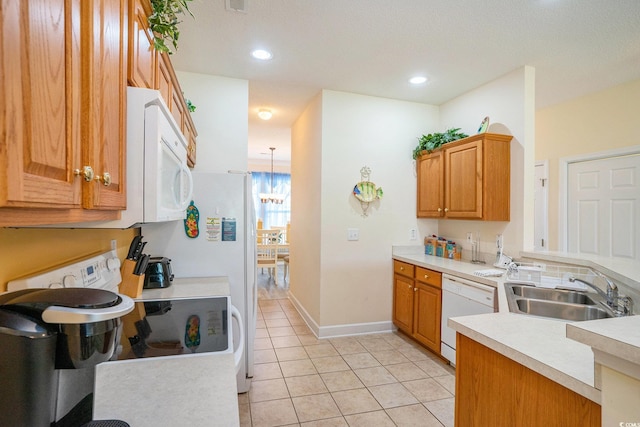 6172 Catalina Dr Unit 414H, North Myrtle Beach, SC 29582 - kitchen featuring white appliances, a peninsula, light countertops, light tile patterned floors, and brown cabinetry
