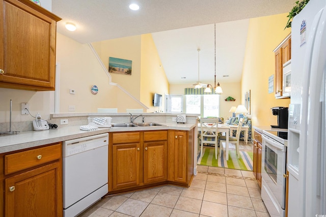 6172 Catalina Dr Unit 414H, North Myrtle Beach, SC 29582 - kitchen featuring white appliances, a peninsula, brown cabinets, light countertops, and light tile patterned flooring