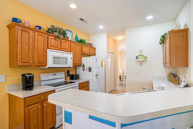 6172 Catalina Dr Unit 414H, North Myrtle Beach, SC 29582 - kitchen with white appliances, light countertops, recessed lighting, brown cabinets, and a peninsula