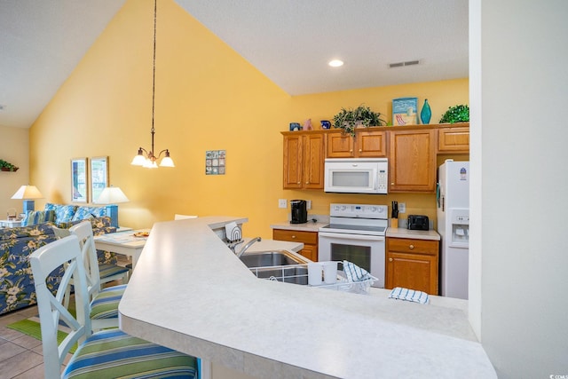 6172 Catalina Dr Unit 414H, North Myrtle Beach, SC 29582 - kitchen with white appliances, light countertops, a chandelier, brown cabinets, and lofted ceiling
