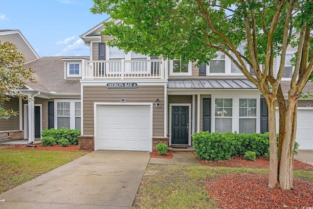 6172 Catalina Dr Unit 414H, North Myrtle Beach, SC 29582 - view of front facade featuring a standing seam roof, driveway, a garage, brick siding, and a balcony