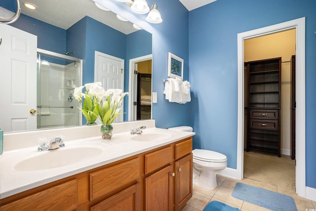 6172 Catalina Dr Unit 414H, North Myrtle Beach, SC 29582 - full bathroom featuring a shower with shower door, double vanity, tile patterned flooring, and a spacious closet